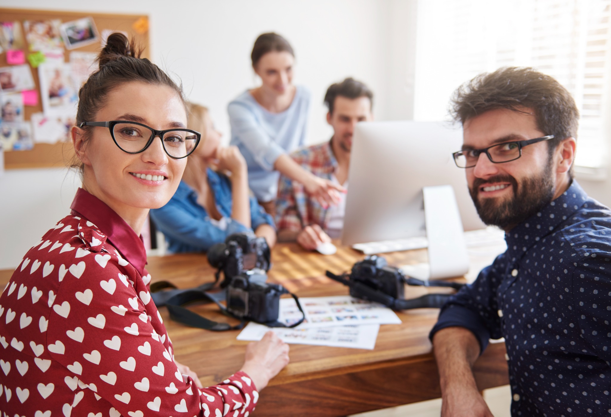 A creative communications team collaborating around a table